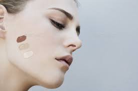 Close-up of a mature woman testing different foundation shades to match skin undertone