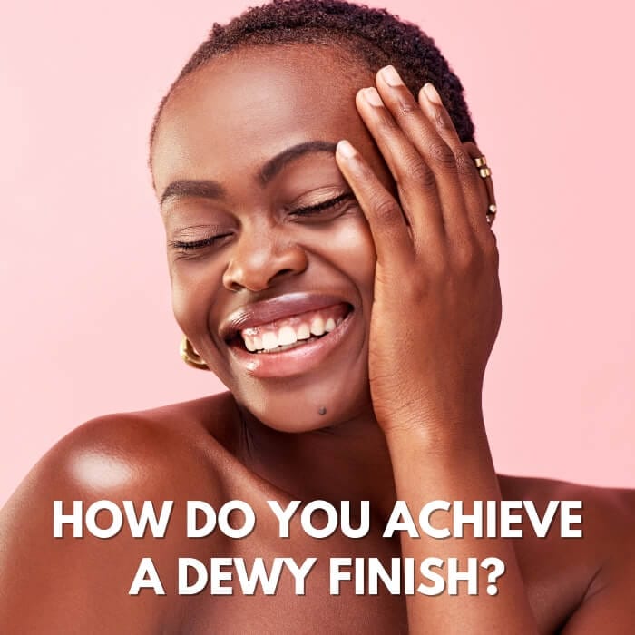 Woman with glowing skin demonstrating how to achieve a dewy makeup finish