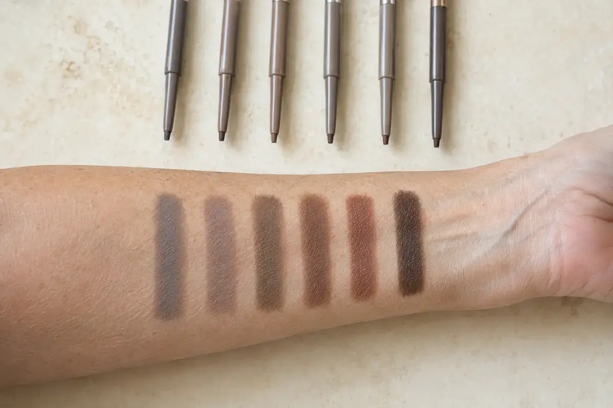 Cool gray, taupe, ash brown and neutral eyebrow pencil shades swatched on mature skin
