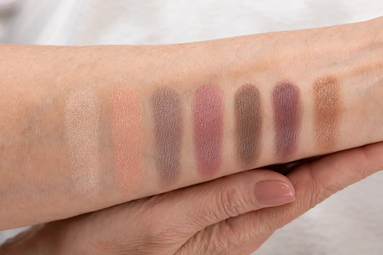 Seven neutral cream eyeshadow swatches on authentic mature skin