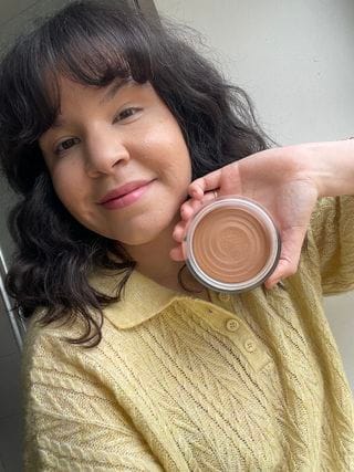 Chanel Les Beiges Healthy Glow Bronzing Cream woman holding the item