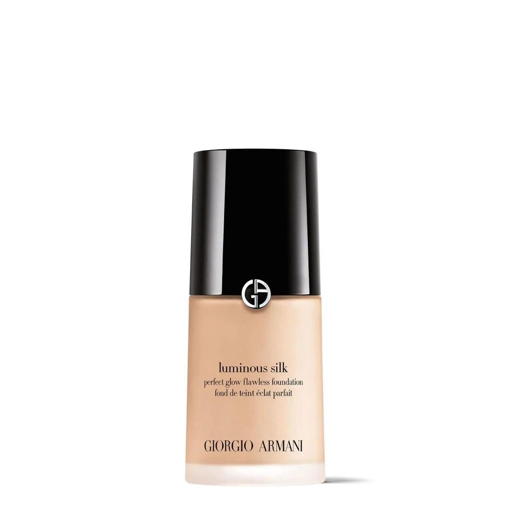 Bottle of Giorgio Armani Luminous Silk Foundation with sleek, minimalist packaging sitting on a marble surface.