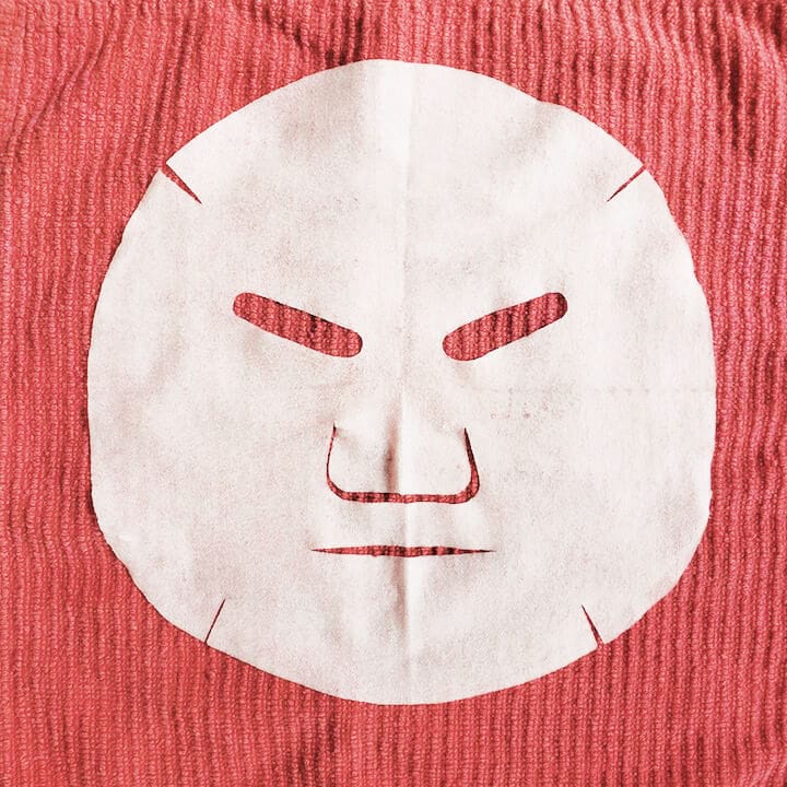 face mask laying on red background Missha Time Revolution Artemisia Jelly Sheet Mask