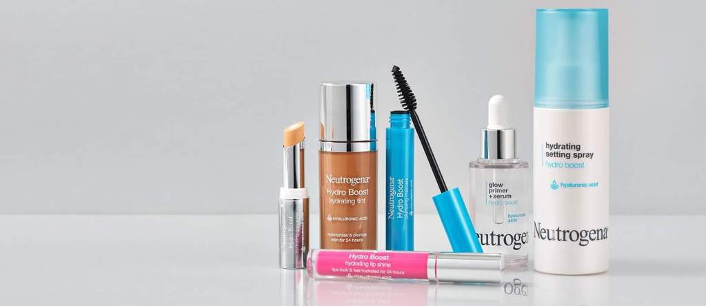 Misting face with hydrating setting spray, depicting set with a hydrating spray for long-lasting dewy makeup on over-50 skin.