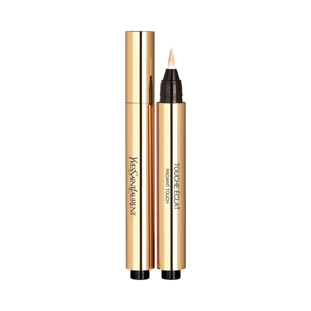 Two gold YSL Touche Éclat radiant touch pens, one closed and one open with a brush applicator, standing upright on a white background.