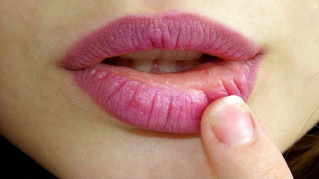 Woman touching her lip with lipstick