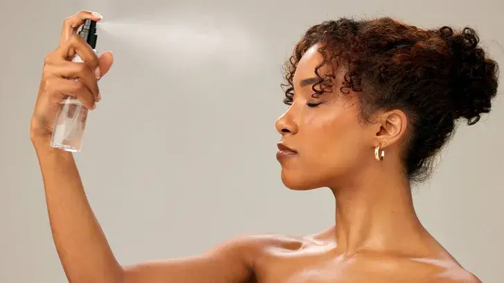 woman using setting spray