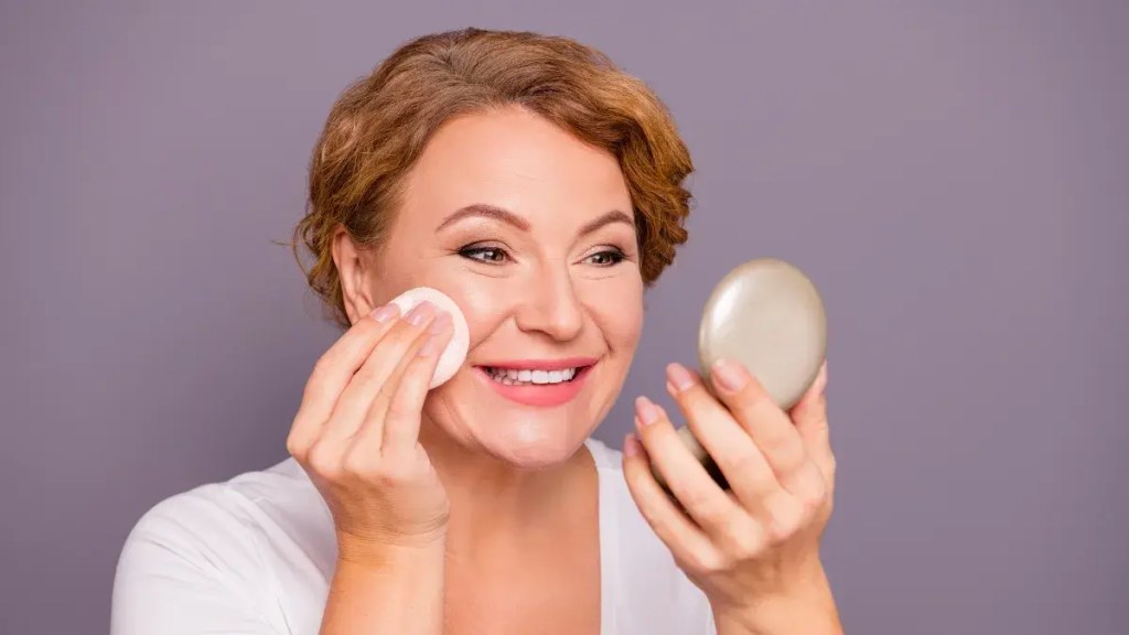 Mature woman finishing her makeup with Setting Spray