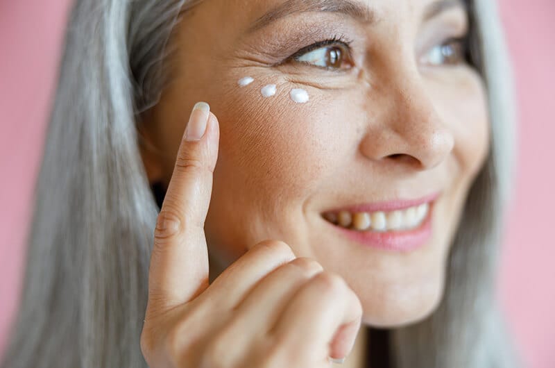 Mature woman applying cream