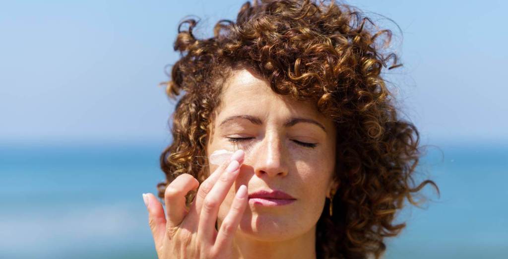 Woman applying sunscreen