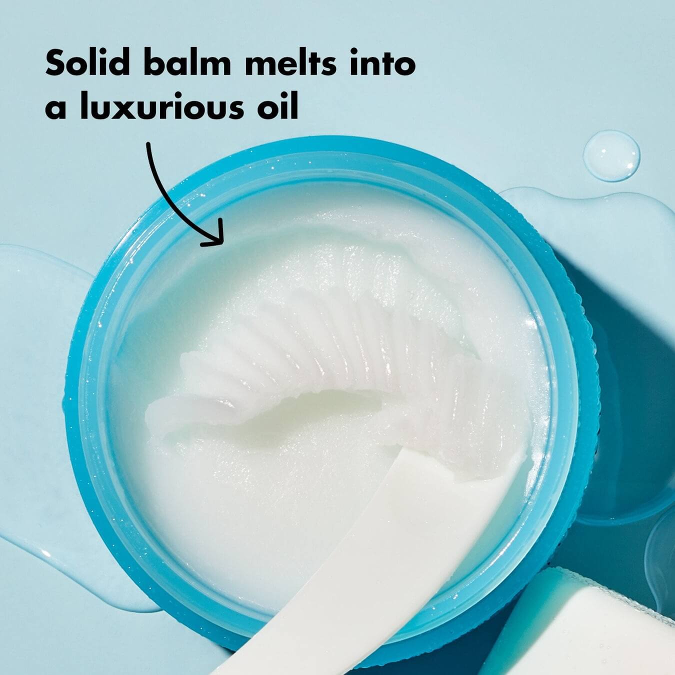 Open e.l.f. cleansing balm showing the solid white balm texture and scoop